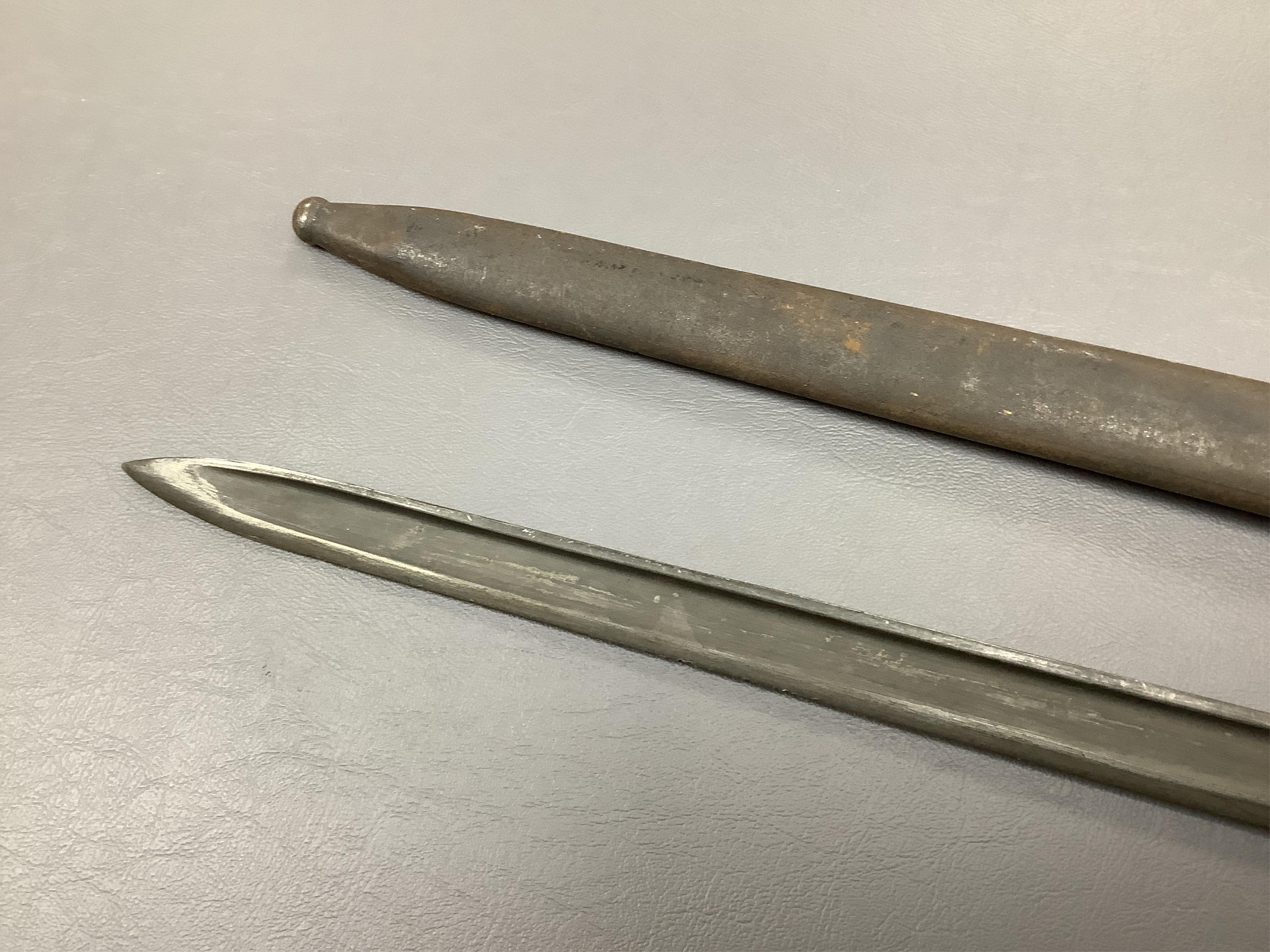 A First World War Turkish army officer’s sword, with pipe back blade, regulation iron guard pierced with crescent and moon, chequered horn grips, in its iron scabbard, together with an unidentified bayonet in its scabbar